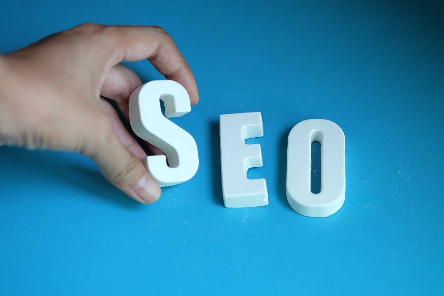 SEO  letters with a hand holding the S